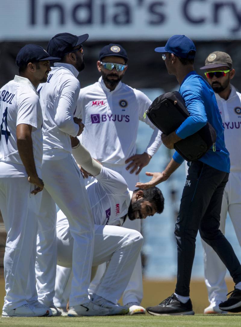 India's bowler Jasprit Bumrah, bottom, hurt his ankle while bowling on Tuesday. AP