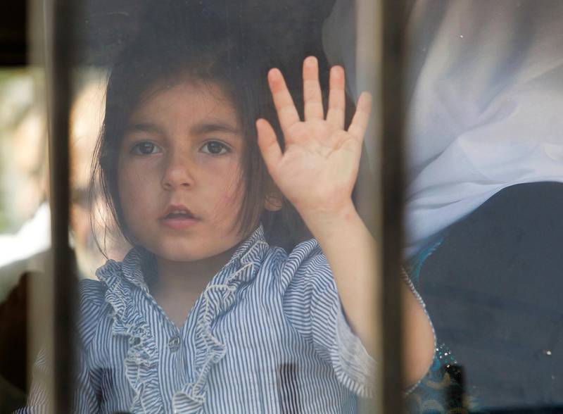 A Syrian refugee girl, who fled to Lebanon, looks through a bus window as she goes back to Syria from the southern village of Shebaa, Lebanon April 18, 2018. REUTERS/Aziz Taher