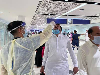 Saudi medical staff give oral medication to the first batch of Muslims from international flights on their way to Umrah. Reuters