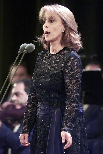 Lebanese diva Fairuz performs at the American University auditorium in Dubai 29 March 2001. Fairuz, 66, is accompanied by a 40-member orchestra and chorus, including several musicians from the national Armenian philharmonic. Her last performance in the Beiteddine festival in Lebanon last July drew an audience of 18 000 people over three packed nights in the historic palace of Mir Beshir in the pine forests of the Shouf mountains, southeast of Beirut. (Photo by JORGE FERRARI / AFP)