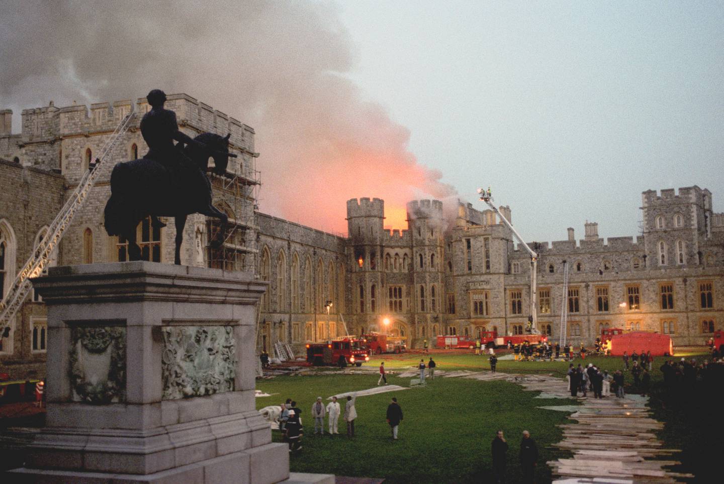 Windsor Castle as dusk falls after fire swept through the queen's primary royal home. PA.