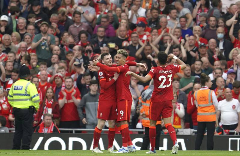 Liverpool players celebrate after Mohamed Salah scores against Wolves. AP