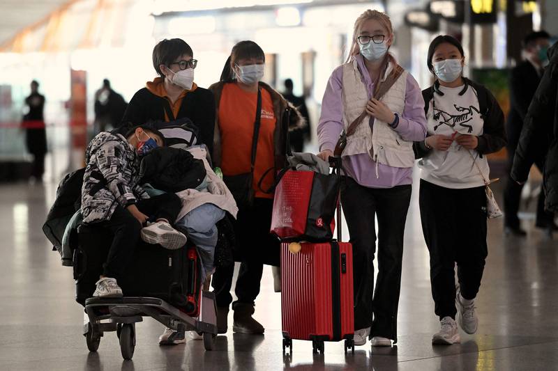 Passengers at a Beijing airport. China is experiencing an increase in Covid case numbers. AFP