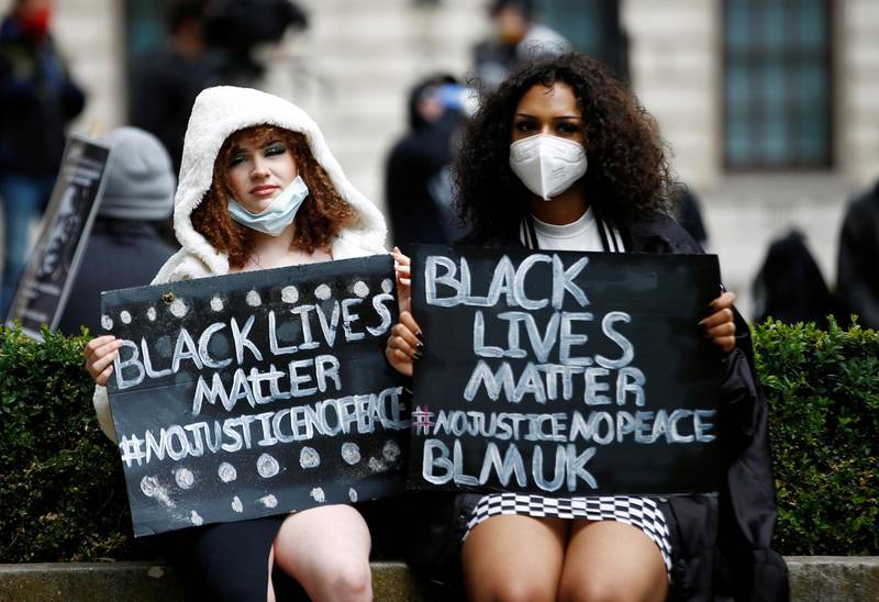 Demonstrators wearing protective face masks attend a Black Lives Matter protest in London's Parliament Square on June 6, 2020, following the death of George Floyd in police custody in Minneapolis. Reuters