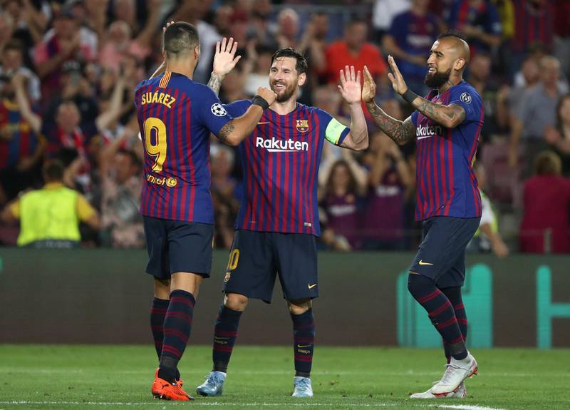 Barcelona's Lionel Messi celebrates with Luis Suarez and Arturo Vidal after scoring their fourth goal to complete his hat-trick. Reuters