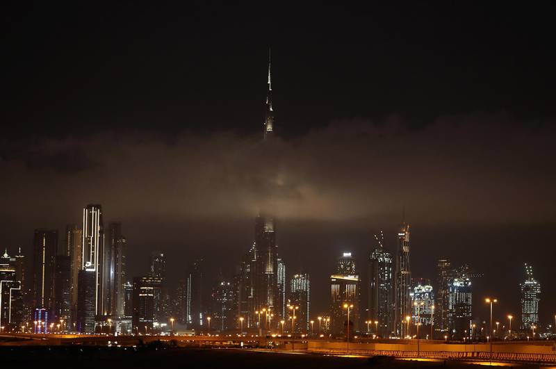 DUBAI, UNITED ARAB EMIRATES , April 15 – 2020 :-  Clouds covering the Burj Khalifa after the rain in Dubai. (Pawan Singh/The National) For News/Standalone/Online/Instagram/Big Picture