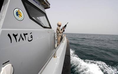 A Saudi border guard watches as he stands in a boat off the coast of the Red Sea on Saudi Arabia's maritime border with Yemen, near Jizan April 8, 2015. Iran sent two warships to the Gulf of Aden on Wednesday, state media reported, establishing a military presence off the coast of Yemen where Saudi Arabia is leading a bombing campaign to oust the Iran-allied Houthi movement. REUTERS/Faisal Al Nasser - GF10000052470