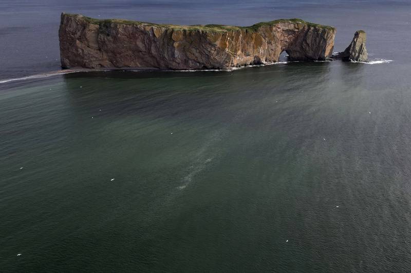 Perce Rock off the coast of Quebec, Canada, shows the natural processes of erosion, even without climate change. All photos: AP