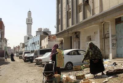 Immigrants women stand near boxes of vegetables in the Jeddah slum of Karantina, February 12, 2013, Saudi Arabia. Reuters 