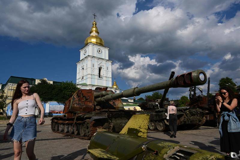 Ukrainians look at destroyed Russian military equipment at an outdoor exhibition near the Church of the Three Saints in Kyiv. AFP