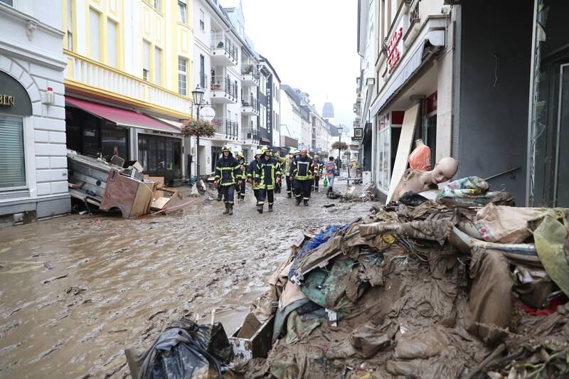 Members of the fire department wade through the water to inspect the damage in Bad Neuenahr-Ahrweiler, Germany.