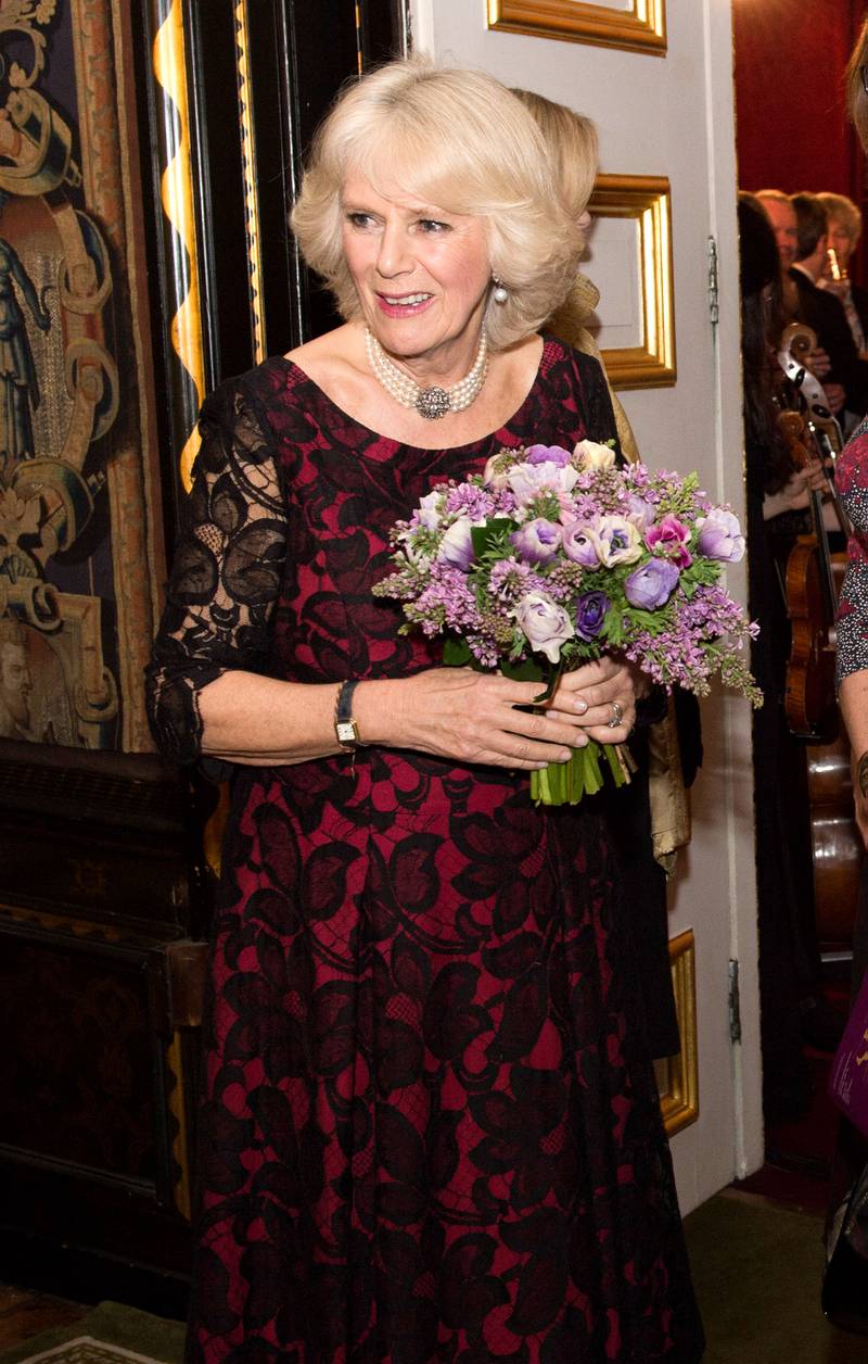 Camilla, dressed in a black and red lace gown, attends a Gala Concert and Reception to mark the 125th Anniversary of I CAN at St James's Palace on January 21, 2014 in London. Getty Images