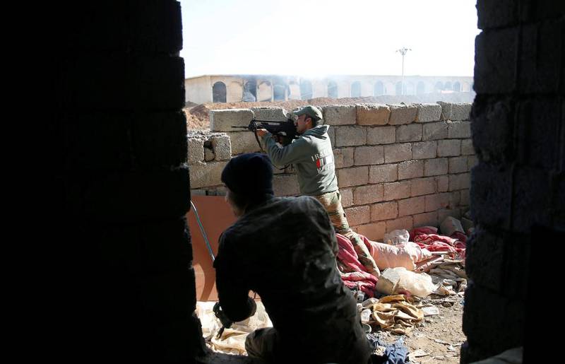 Iraqi security forces fire at targets during clashes with Islamic State militants, north of Mosul, Iraq.