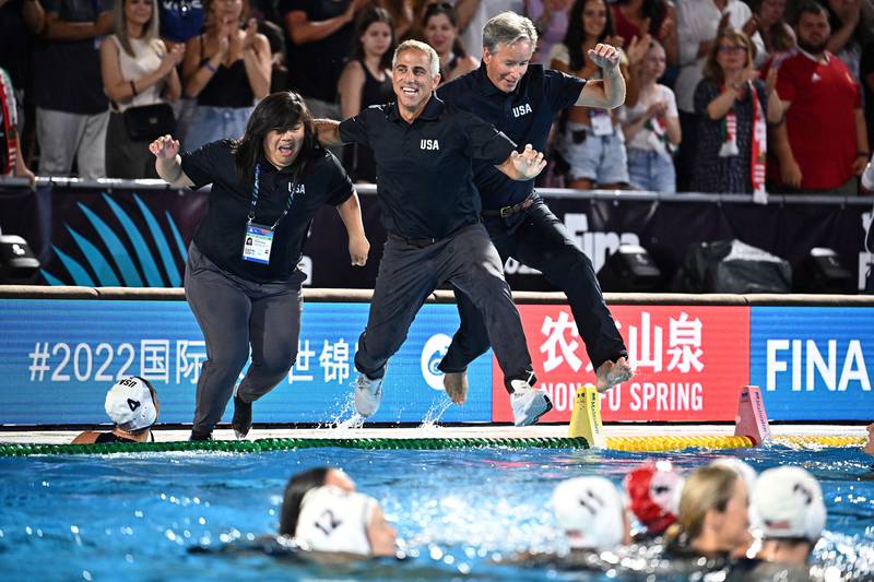 The US coaching team leap into the pool after their players beat Hungary in the women's world waterpolo final in Budapest. Reuters