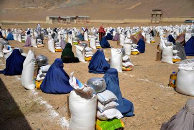 Afghan women receive food from foreign aid in Kandahar on August 10, 2023. AFP