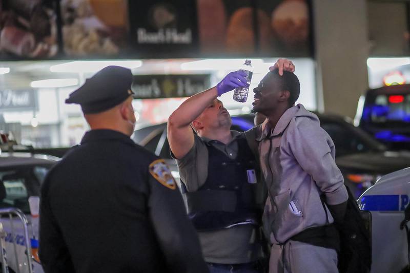 Officers with the New York Police Department render aide to a detained suspected looter in Manhattan during protests over the Minnesota arrest of George Floyd, who later died in police custody, in New York City.  EPA