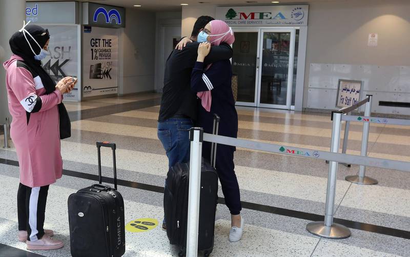 A woman embraces a man before she heads to board a plane at Beirut International airport, Lebanon. Reuters
