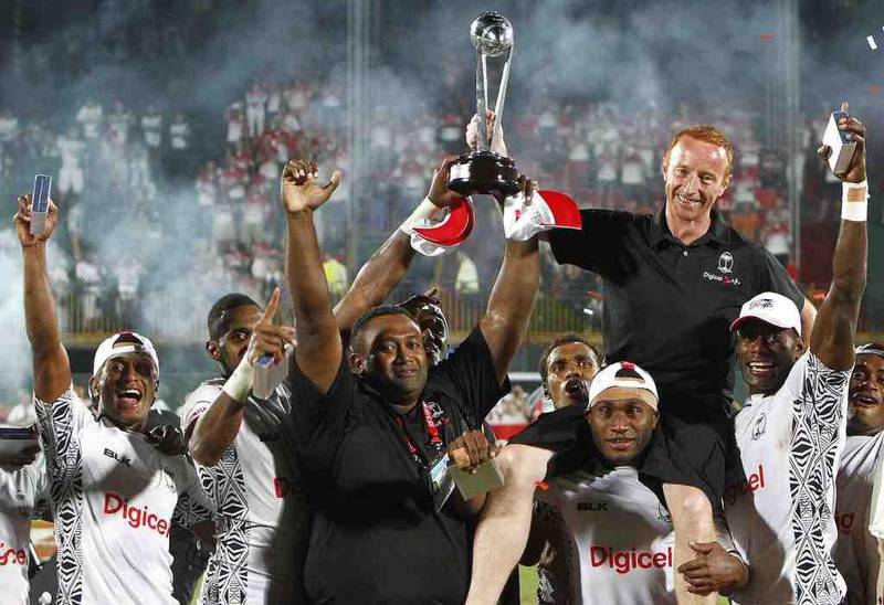 Fiji, then coached by Ben Ryan, second left in black shirt, are crowned Dubai Rugby Sevens winners on November 30, 2013. Jake Badger for The National 