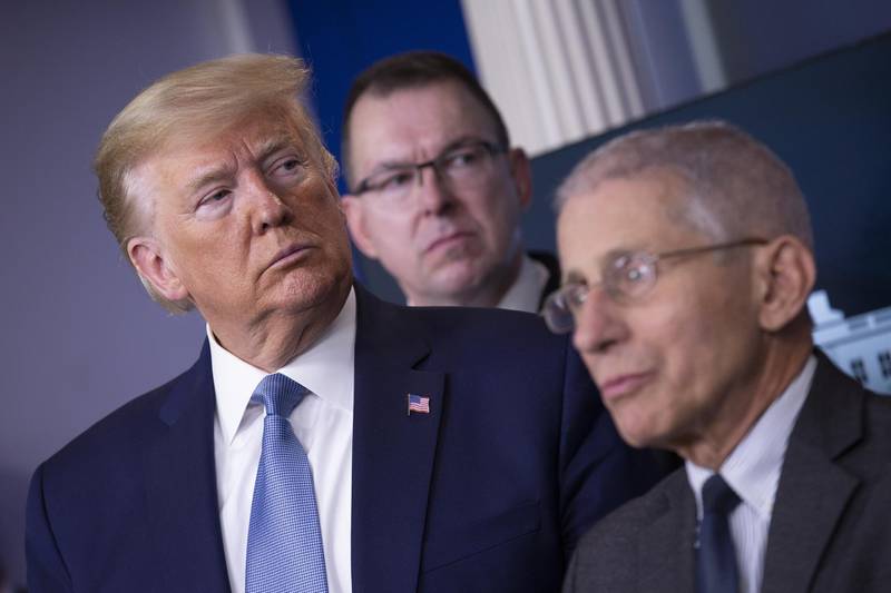 U.S. President Donald Trump, left, listens during a Coronavirus Task Force news conference in the briefing room of the White House in Washington, D.C., U.S., on Saturday, March 21, 2020. Trump said negotiators in Congress and his administration are "very close" to agreement on a coronavirus economic-relief plan that his economic adviser said will aim to boost the U.S. economy by about $2 trillion. Photographer: Stefani Reynolds/CNP/Bloomberg