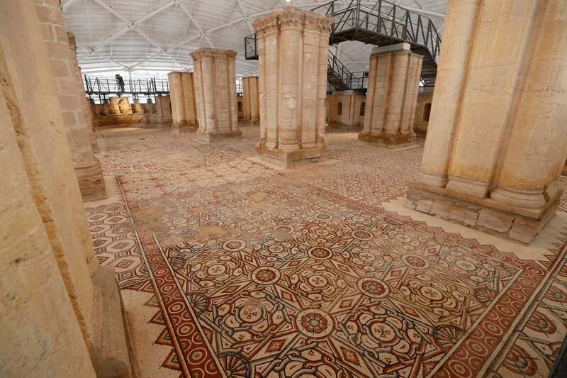 A general view shows a large mosaic after restoration at Hisham's Palace, an early Islamic archaeological site, in the West Bank city of Jericho, 28 October 2021.  The mosaic floor dating back to the Umayyad era contains 38 carpet-like connected panels covering ca.  827 square meters.  The multi-year restoration project, done in cooperation between the Palestinian Ministry of Tourism and Antiquities and the Japanese International Cooperation Agency (JICA) at a cost of 12 million USD, includes the construction of a protective roof and exhibition facilities.  
Hisham's Palace, built in the first half of the 8th century AD, is attributed to the Umayyad Caliph Hisham ibn Abd al-Malik.  The mosaic was previously buried with sand and insulating materials for many years to protect it from climatic influences.   EPA / ATEF SAFADI