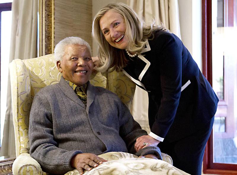 US Secretary of State Hillary Rodham Clinton meets with Nelson Mandela, 94, former president of South Africa, at his home in Qunu, South Africa, on August 6, 2012. Her private lunch with the Nobel Peace Prize winner was the first event of her South African visit, an indication of the prestige still enjoyed by the man who led the fight against white-minority rule. The two chatted in his home ahead of the meal, an honour that few receive as Mandela's health has become more fragile with age.  AFP PHOTO/POOL/ Jacquelyn Martin (Photo by JACQUELYN MARTIN / POOL / AFP)