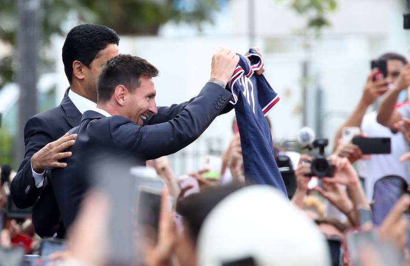 Paris St Germain's Lionel Messi and president Nasser Al-Khelaifi with fans outside the stadium after the press conference.