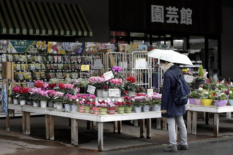A prospective flower-buyer in Yokohama, Japan, on December 2. Bloomberg