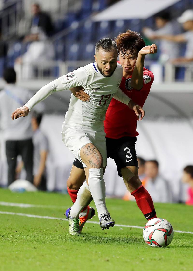DUBAI , UNITED ARAB EMIRATES , January  7 ��� 2019 :- Carlos Alberto ( no 3 in red ) of Korea Republic and Stephan Schrock ( no 17 in white ) of Philippines in action during the AFC Asian Cup UAE 2019 football match between KOREA REPUBLIC vs. PHILIPPINES held at Al-Maktoum Stadium in Dubai. Korea Republic won the match by 1-0. ( Pawan Singh / The National ) For News/Sports