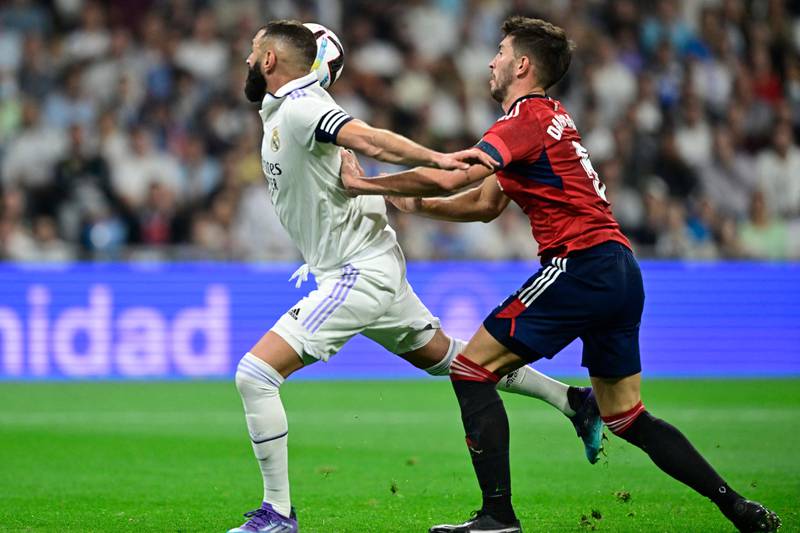Osasuna defender David Garcia fouls Karim Benzema to concede a penalty. AFP