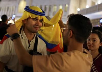 A football fan wears a traditional Arab head dress with the flag of Ecuador in Souq Waqif, Doha. Reuters