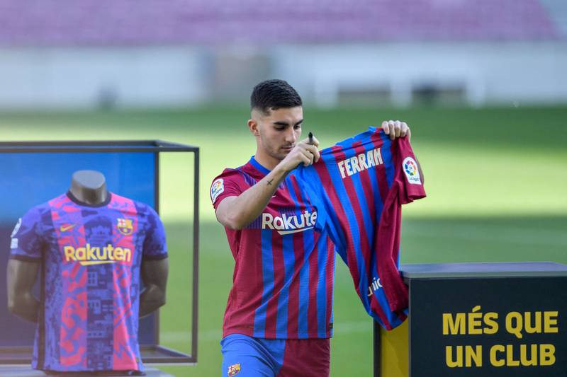 Barcelona's new midfielder Ferran Torres signs his jersey during his official presentation ceremony at Camp Nou. AFP