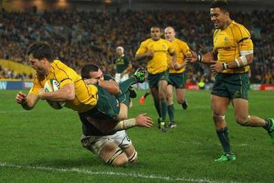 Adam Ashley-Cooper goes over for Australia’s fifth try during their 39-20 victory over South Africa in the opening match of the Tri Nations in Sydney yesterday.