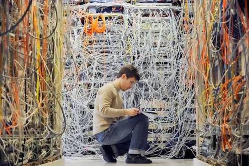 An engineer checks communication cables in the Media Gateway lab in Ericsson's research and development center in Budapest, Hungary.