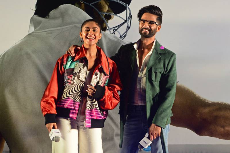Shahid Kapoor, right, and Mrunal Thakur promote their movie 'Jersey'. AFP