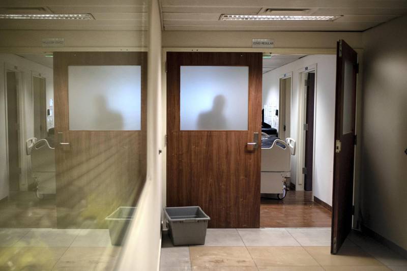 ©2021 Tom Nicholson. 18/01/2021. Beirut, Lebanon. A person is silhouetted behind a door near the Coronavirus intensive care unit at the American University of Beirut (AUB) Hospital. Deaths from Coronavirus in Lebanon reached a peak high of 53 today. Photo credit : Tom Nicholson