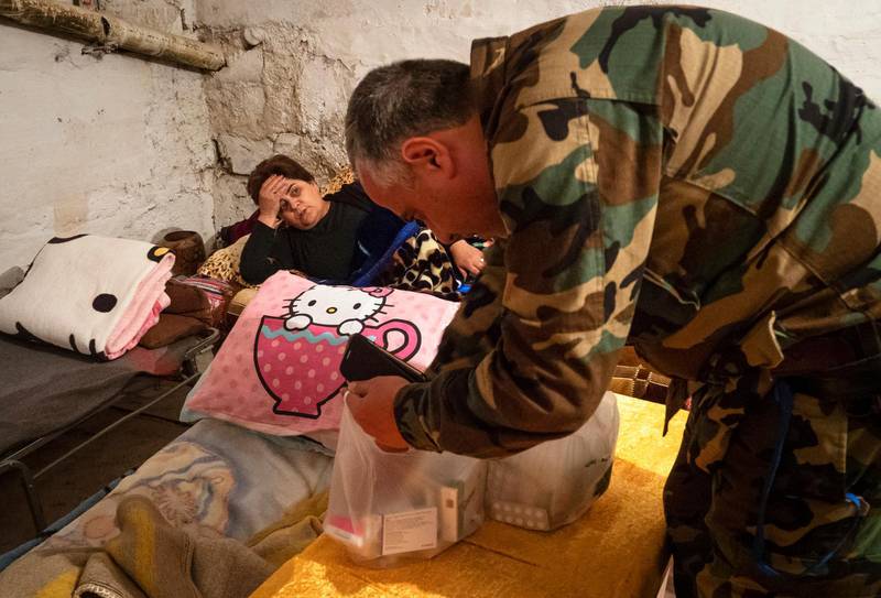 Volunteer doctor Aram Grigoryan gives drugs to a sick woman taking refuge in a bomb shelter in Stepanakert, the separatist region of Nagorno-Karabakh. AP