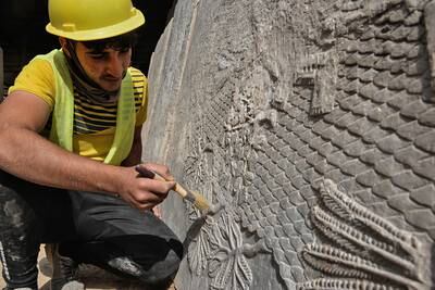 An Iraqi worker excavates a rock-carving relief at the Mashki Gate, one of the entrances to the ancient Assyrian city of Nineveh, on the outskirts of Mosul. AFP