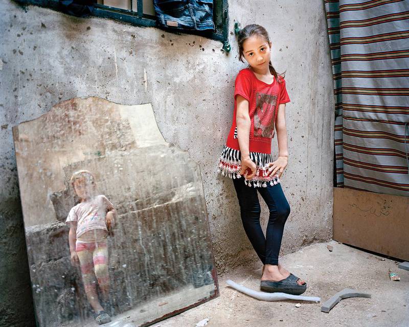 Amal, 9 and Zahra, 5 (girl reflected in mirror), Beirut, Lebanon, 2014 from Invisible Children series