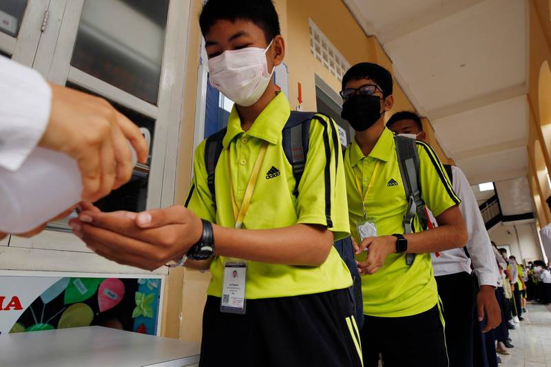 Students sanitize hands to avoid the contact of coronavirus before their morning class at a high school in Phnom Penh, Cambodia. AP Photo