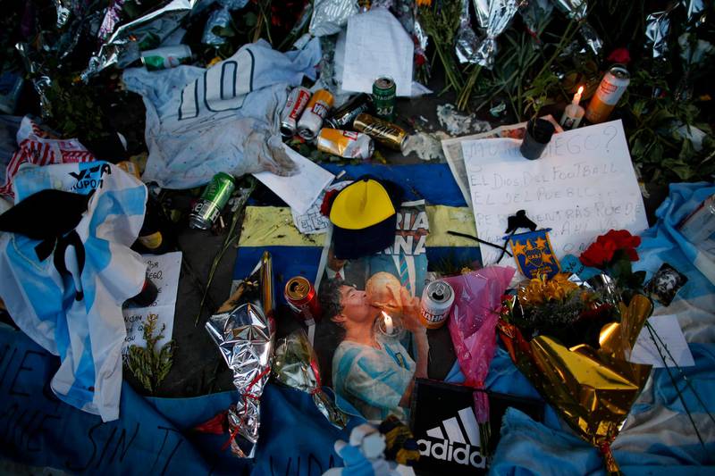 Flowers and posters left in tribute to Diego Maradona sit at the entrance of the Boca Juniors stadium. AP