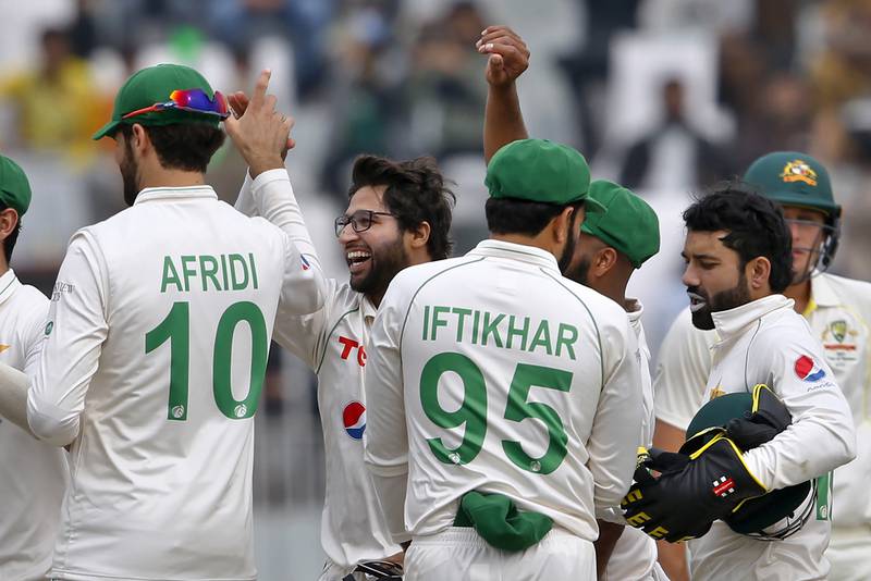 Pakistan's Imam-ul-Haq, second left, celebrates after taking the catch of Australia's Usman Khawaja. AP