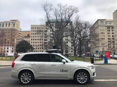 An Uber car equipped with cameras and sensors drives the streets of Washington. The company agreed to sell its autonomous car division to Aurora in a deal that gives the ride-hailing giant a stake in the start-up. AFP