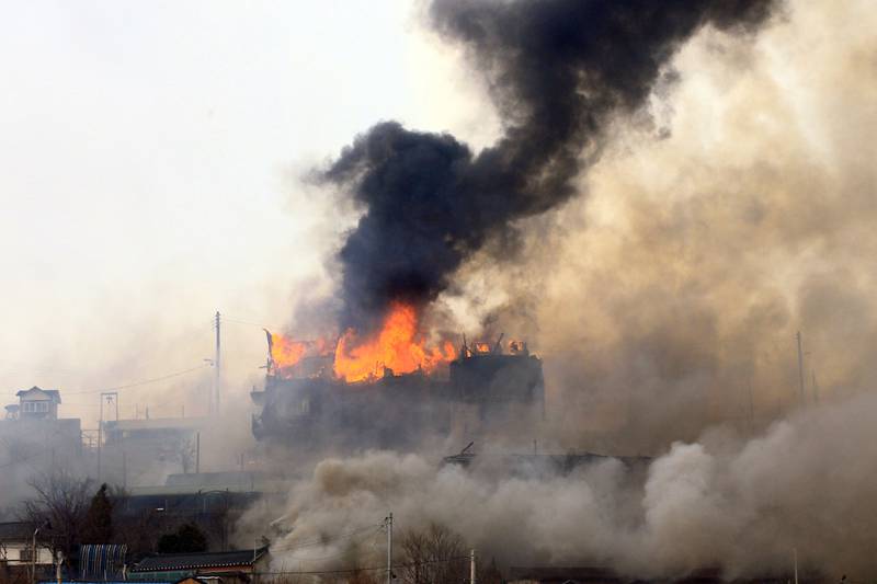 Houses burn in the Donghae district as the fire spreads. AFP