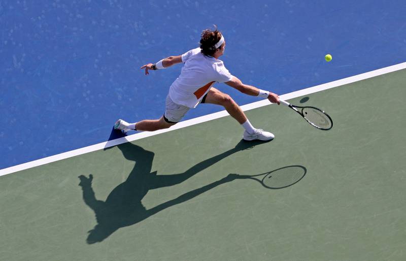 Andrey Rublev reaches for the ball during his match against Mackenzie Mcdonald. AFP
