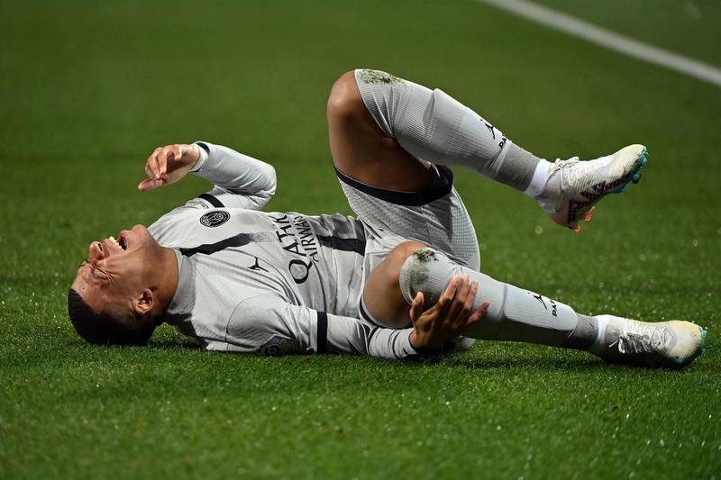 Paris Saint-Germain's French forward Kylian Mbappe lies on the ground after getting injured during the French L1 football match between Montpellier Herault SC and Paris Saint-Germain (PSG) at Stade de la Mosson in Montpellier, southern France on February 1, 2023.  (Photo by Sylvain THOMAS  /  AFP)