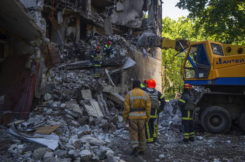 Ukrainian emergency works at a damaged building following shelling in Kharkiv. AP