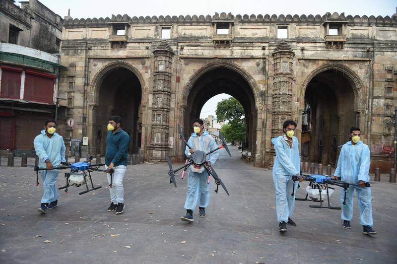 Members of "Team Drone Masters" after spraying disinfectant d in Ahmedabad, India.  AFP