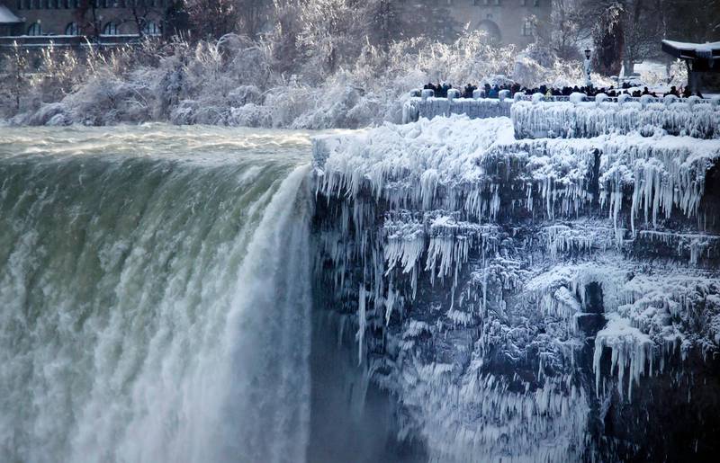 The banks around the Horseshoe Falls at Niagara Falls in Canada Ont are frozen.  Aaron Lynett / The Canadian Press via AP