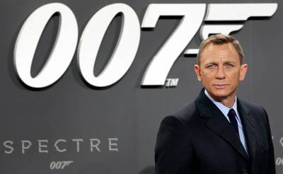 FILE - This is a Wednesday, Oct. 28, 2015 file photo of actor Daniel Craig poses for the media as he arrives for the German premiere of the James Bond movie 'Spectre' in Berlin, Germany. The release of the James Bond film â€œNo Time To Dieâ€ has been pushed back several months because of global concerns about coronavirus. MGM, Universal and producers Michael G. Wilson and Barbara Broccoli announced on Twitter Wednesday that the film would be pushed back from its April release to November 2020.  (AP Photo/Michael Sohn/File)