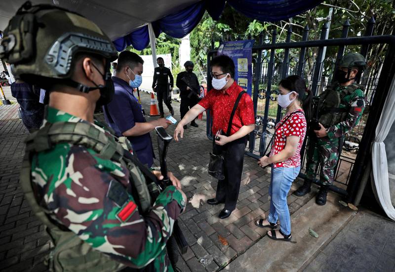 Indonesian soldiers check worshippers at the entrance to the St Mary of the Assumption Cathedral in Jakarta during a Good Friday service on April 2, 2021, five days after the church was attacked. AP Photo
